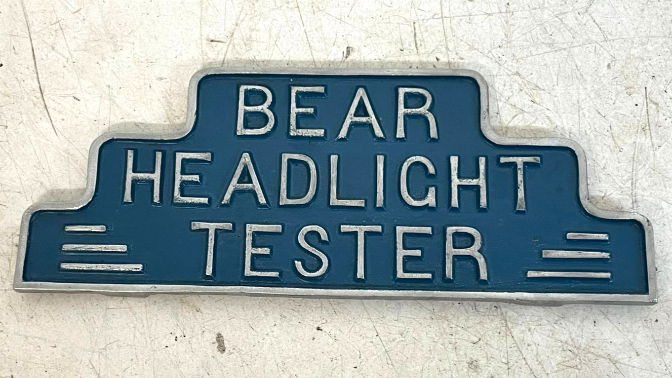 Vintage Bear Headlight Tester Metal Equipment Topper Sign Damaged