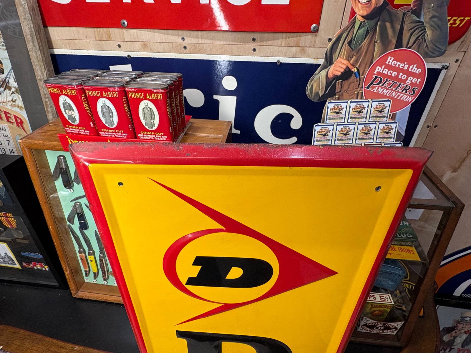 ORIGINAL 1965 “DUNLOP TIRES” LARGE EMBOSSED METAL DEALER SIGN, (60″x 14″) NICE