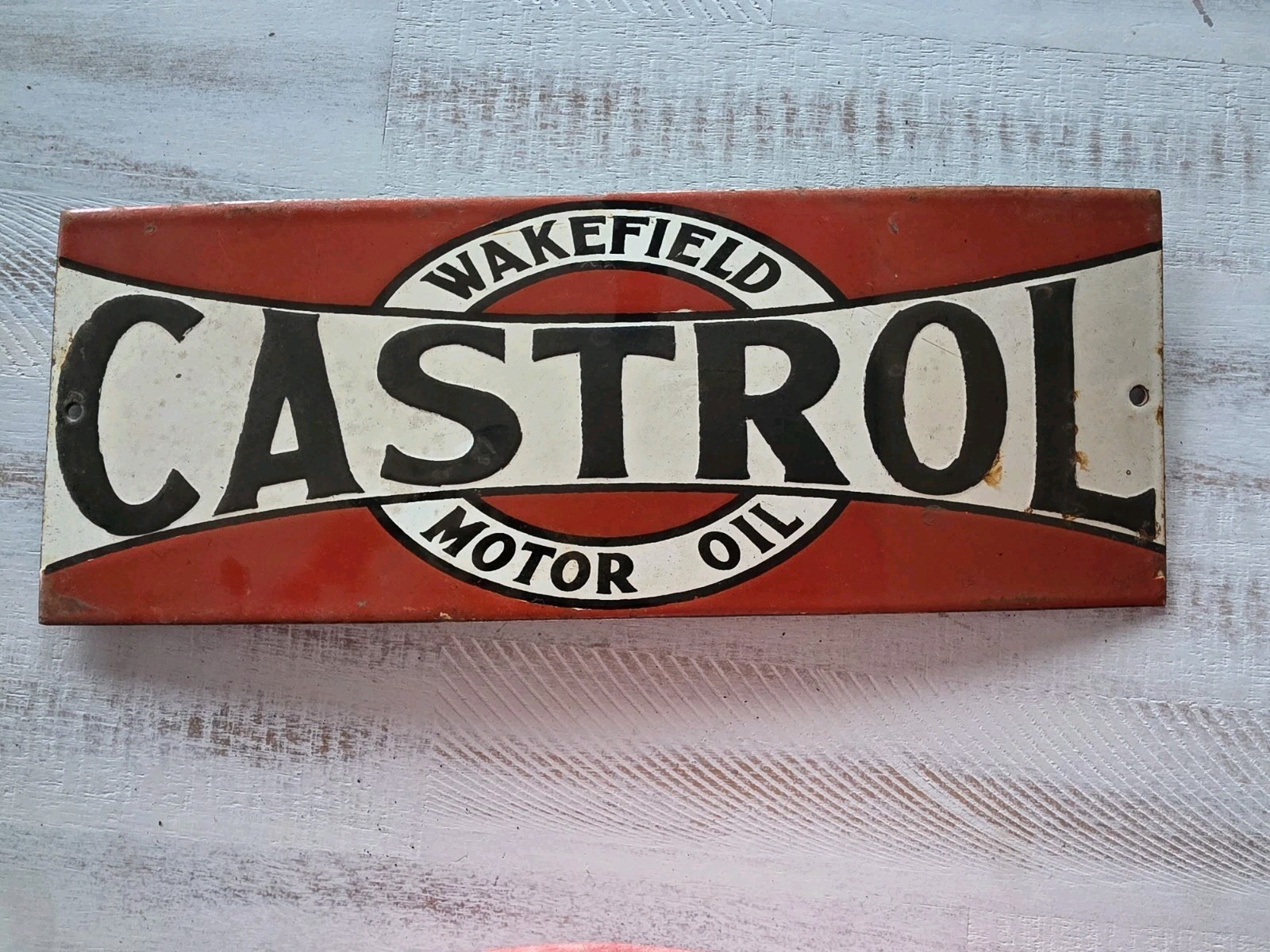 VINTAGE WAKEFIELD CASTROL MOTOR OIL PORCELAIN SIGN 16″×6″.