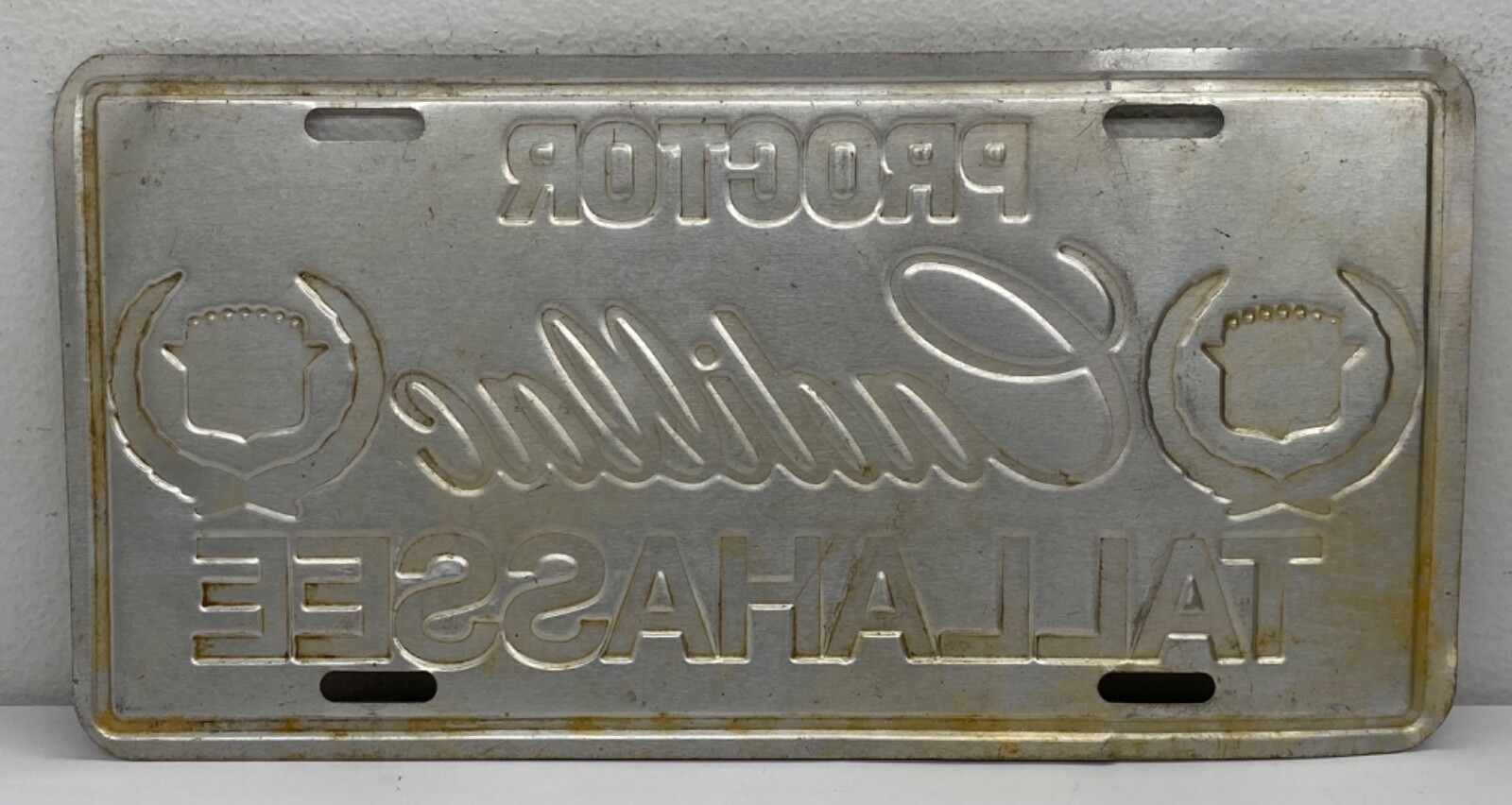 Vintage 80’s Cadillac Proctor Tallahassee Novelty License Plate Metal Emblem USA