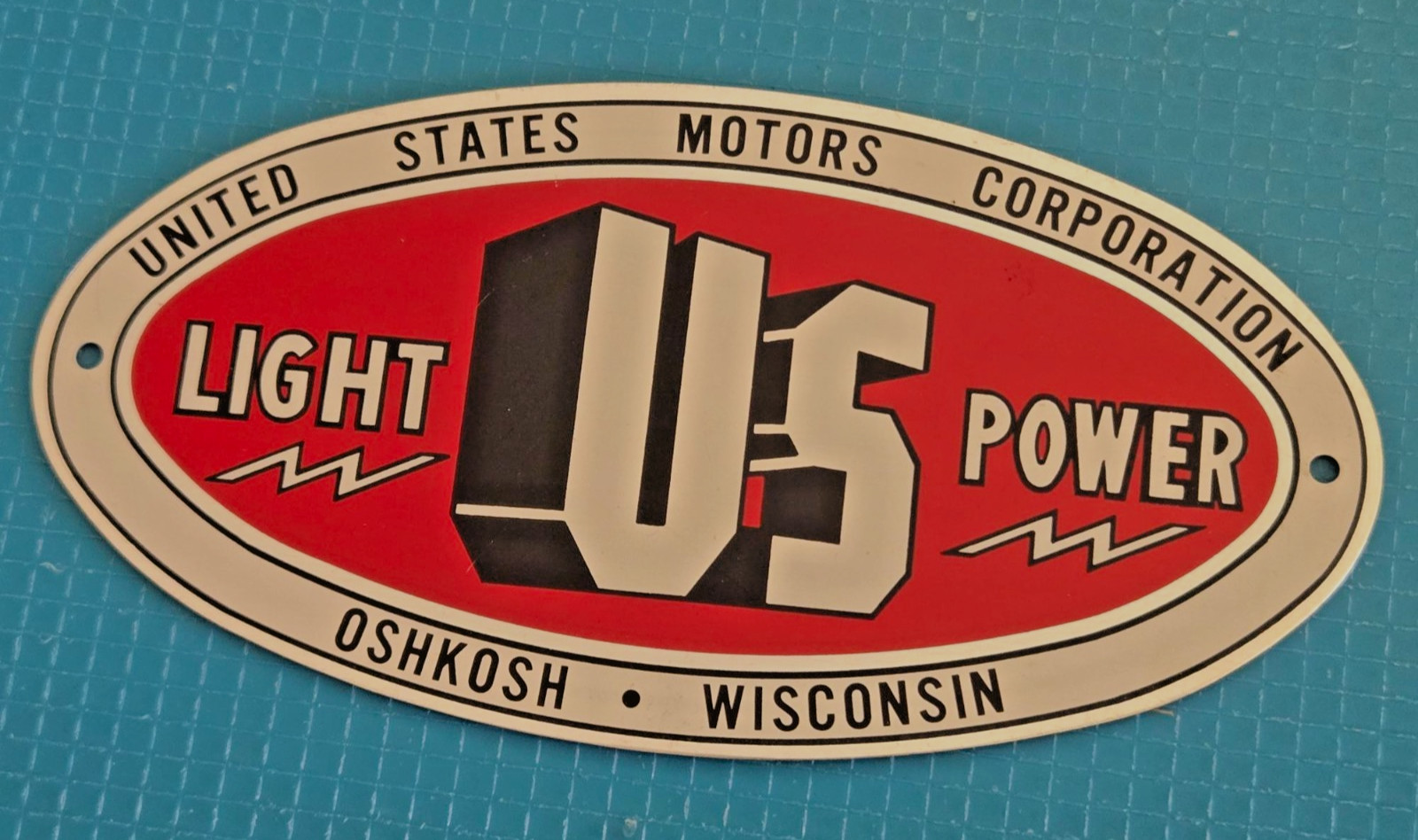 United States Motors Corp.~ Oshkosh, WI ~ LIGHT US POWER ~Advertising Metal Sign