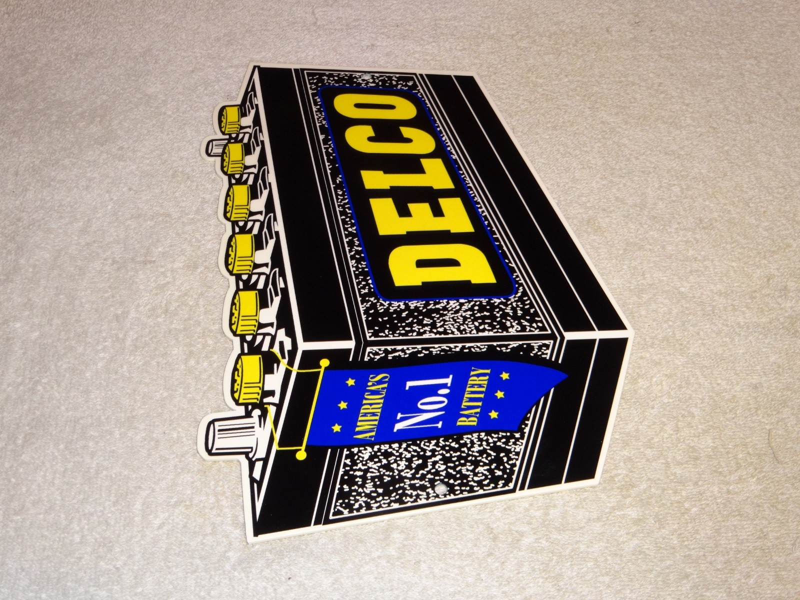 VINTAGE DELCO DIE-CUT BATTERY+ GENERAL MOTORS 12″ ENAMEL METAL GASOLINE OIL SIGN