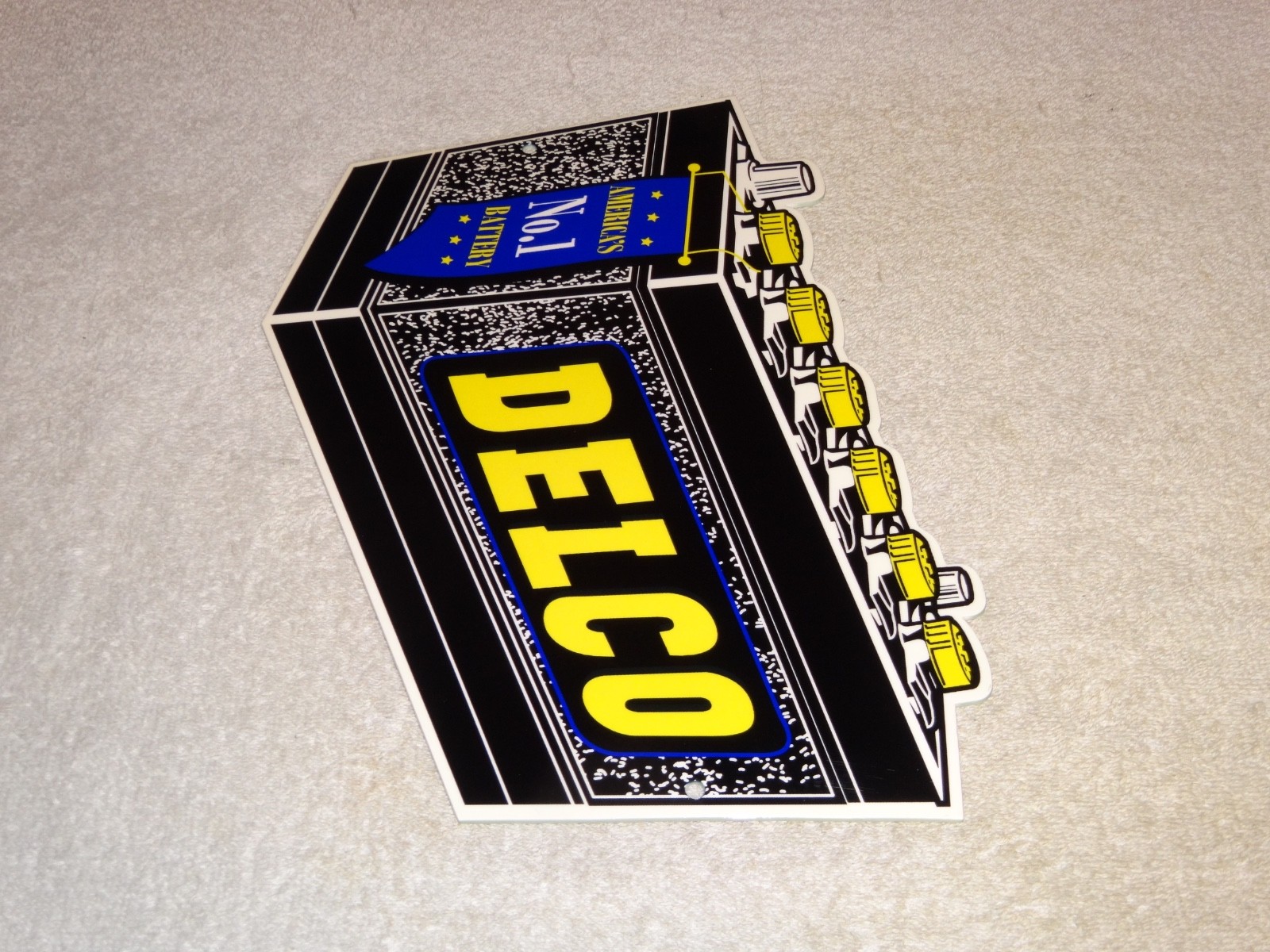 VINTAGE DELCO DIE-CUT BATTERY+ GENERAL MOTORS 12″ ENAMEL METAL GASOLINE OIL SIGN