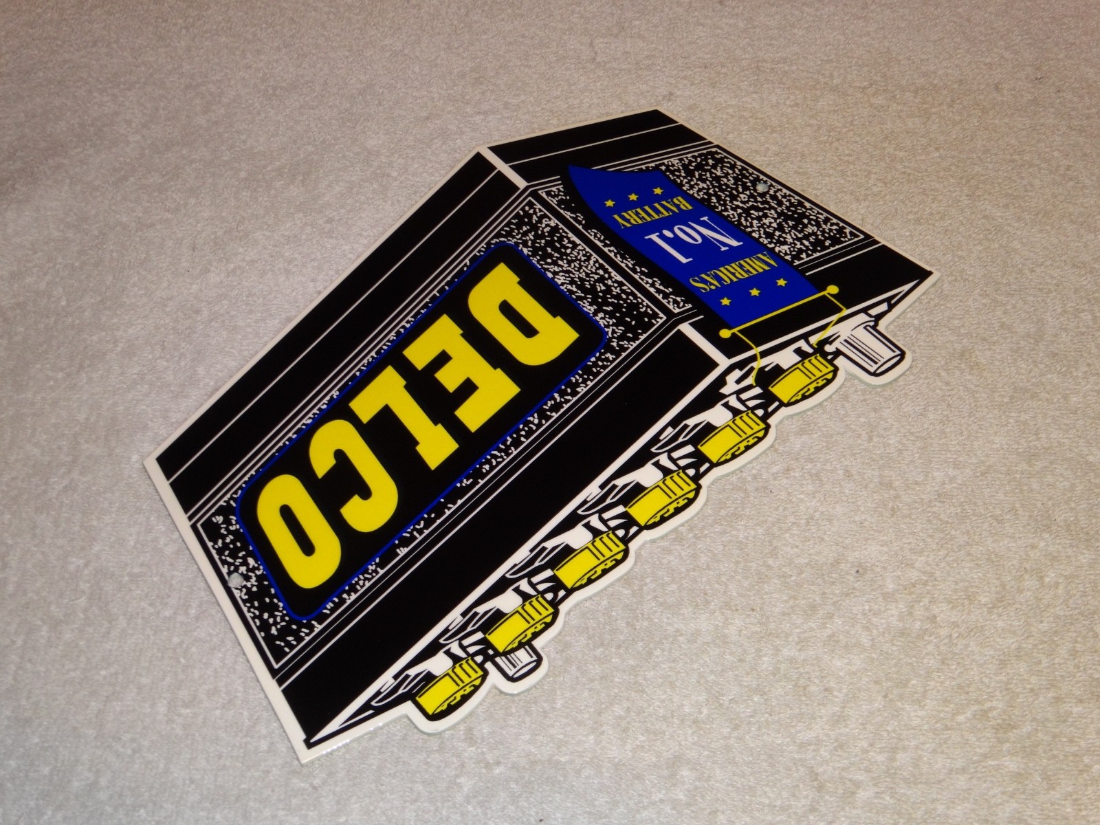 VINTAGE DELCO DIE-CUT BATTERY+ GENERAL MOTORS 12″ ENAMEL METAL GASOLINE OIL SIGN