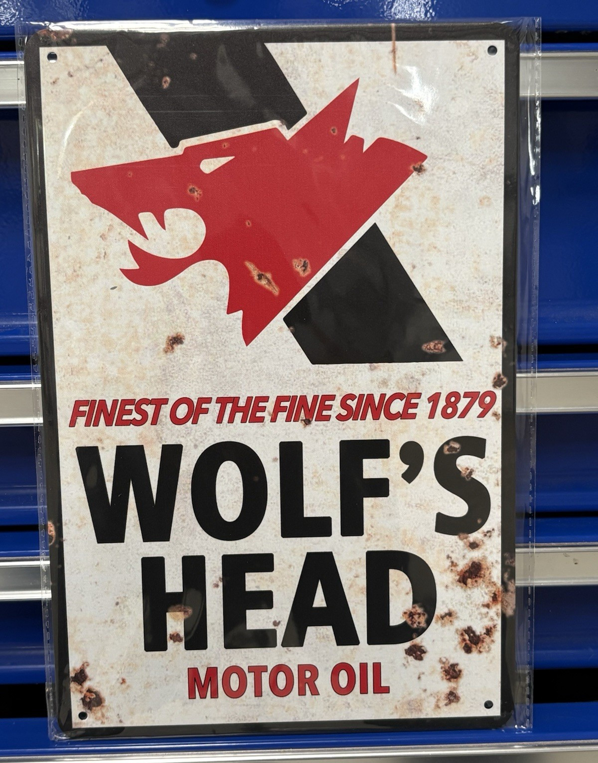 Wolf’s Head Motor Oil Advertising Sign “Finest of the Fine Since 1879” Red