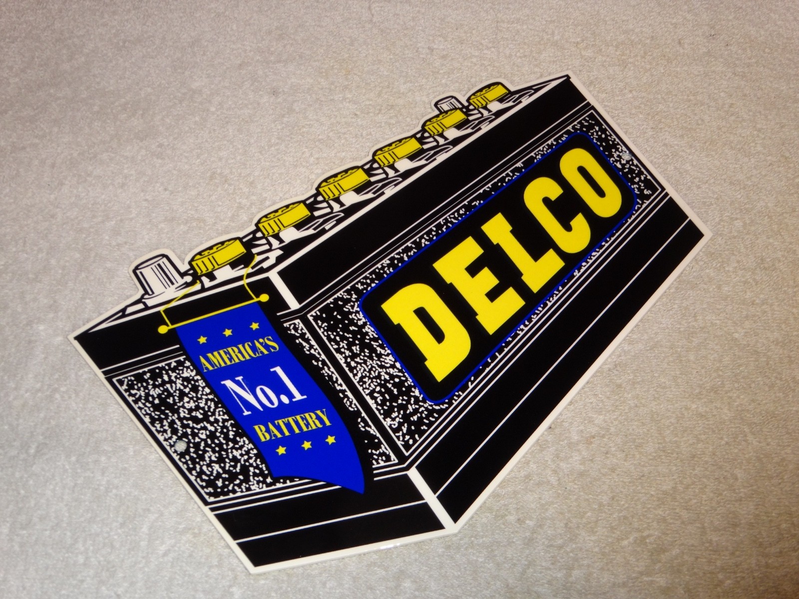 VINTAGE DELCO DIE-CUT BATTERY+ GENERAL MOTORS 12″ ENAMEL METAL GASOLINE OIL SIGN