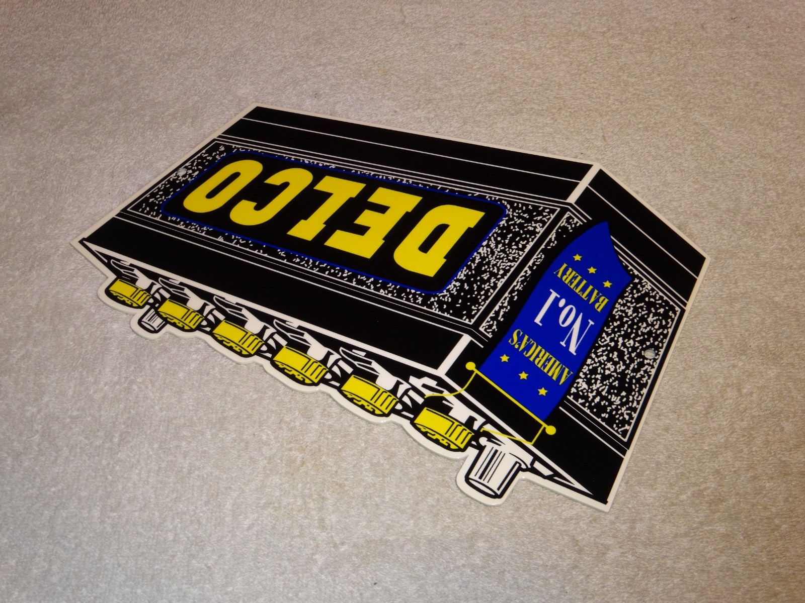 VINTAGE DELCO DIE-CUT BATTERY+ GENERAL MOTORS 12″ ENAMEL METAL GASOLINE OIL SIGN