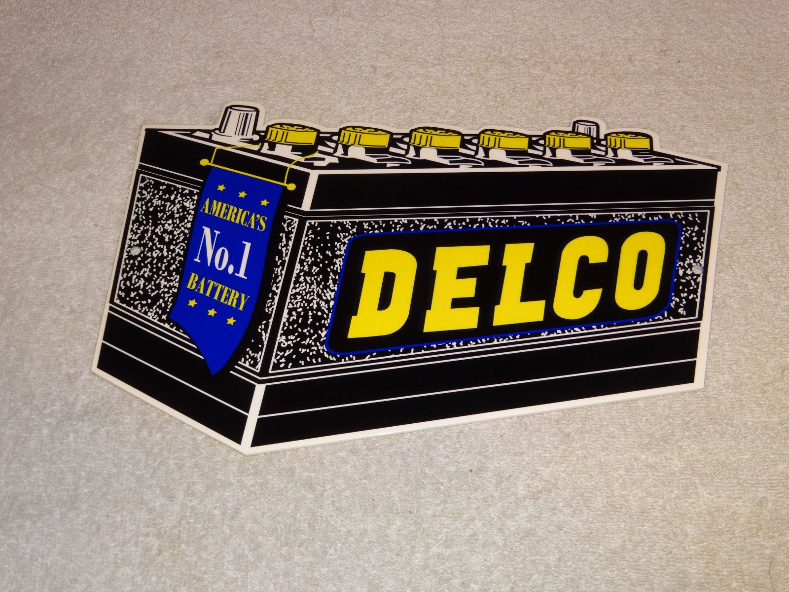 VINTAGE DELCO DIE-CUT BATTERY+ GENERAL MOTORS 12″ ENAMEL METAL GASOLINE OIL SIGN