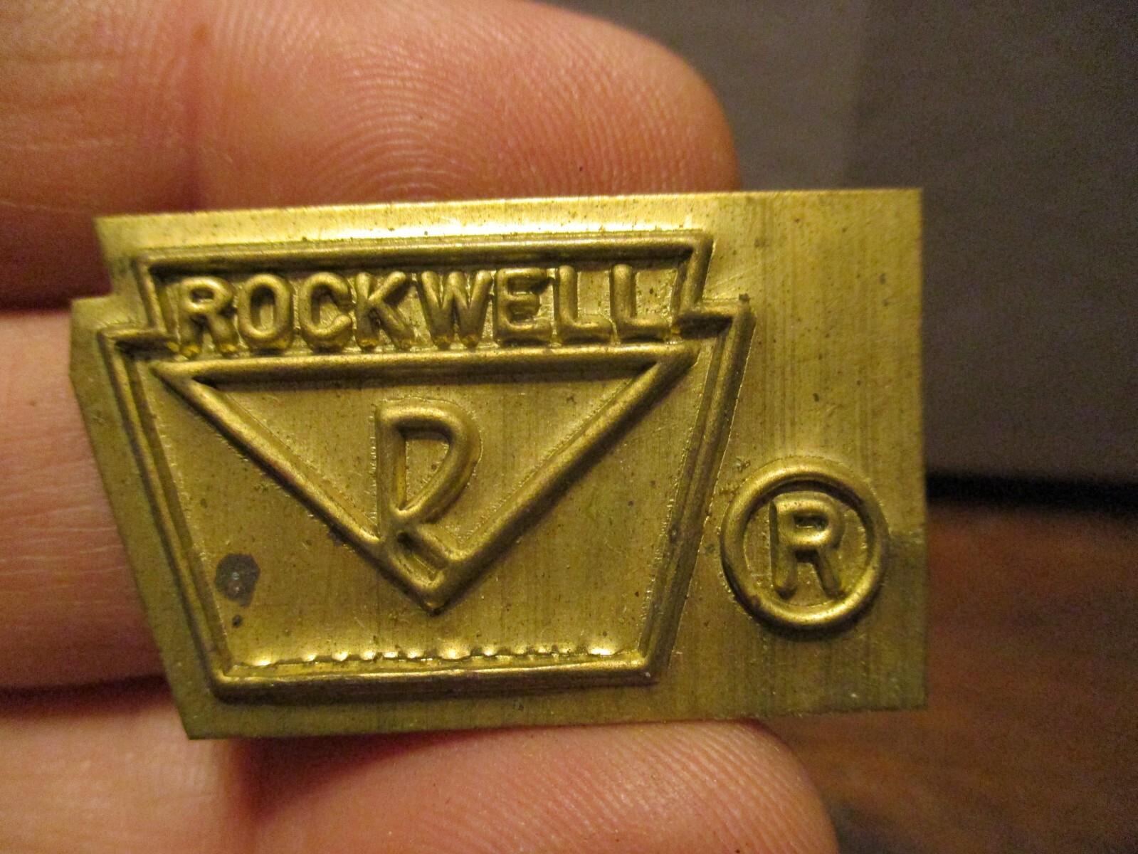ROCKWELL iNTERNATIONAL EMBOSSED BRASS TAG SIGN AXLE MFG CO 1 X 1.5”